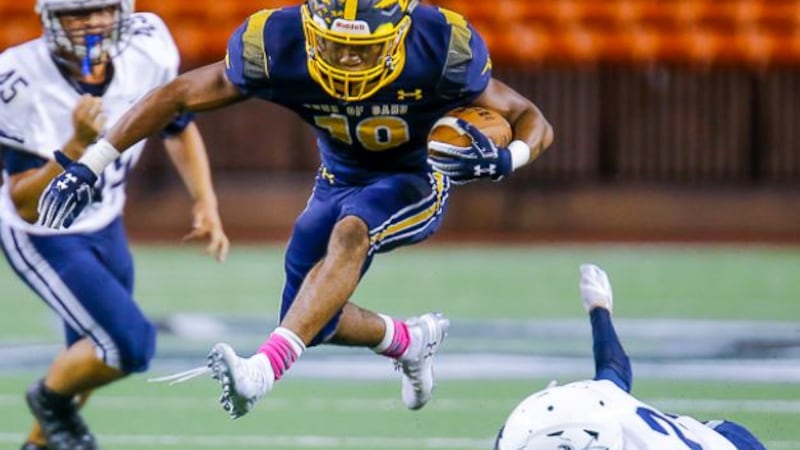 Senior running back Vincent Terrell hurdles Warriors defenders in first half of 47-20 win at...