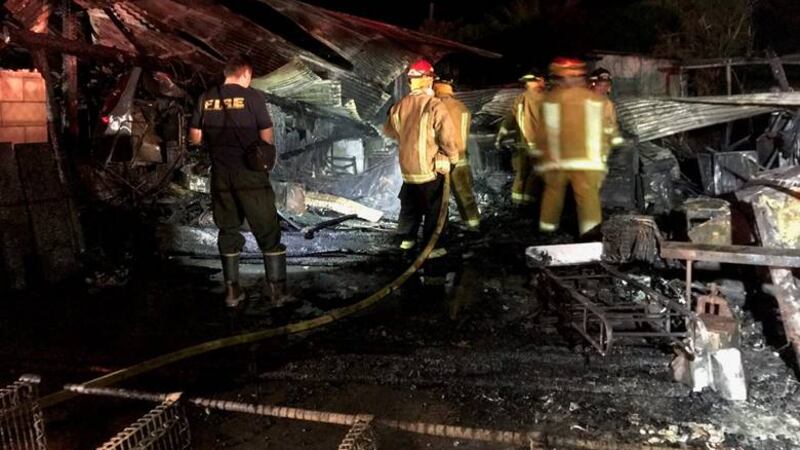 Fire crews assess the damage following the early morning blaze.