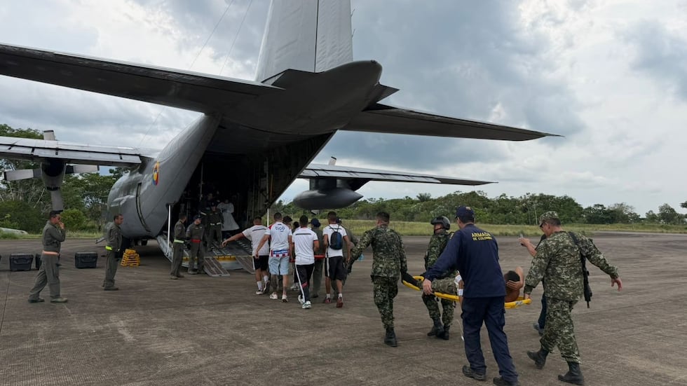 In this photo distributed by Colombia's Armed Forces press office, people who were injured on...