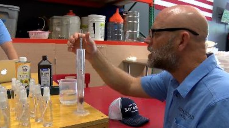 Ko'olau distillery CEO Eric Dill devises hand sanitizer in his Kailua warehouse.