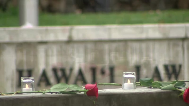 A rose and candle were left for each officer on the Hawaii Law Enforcement Memorial on the...