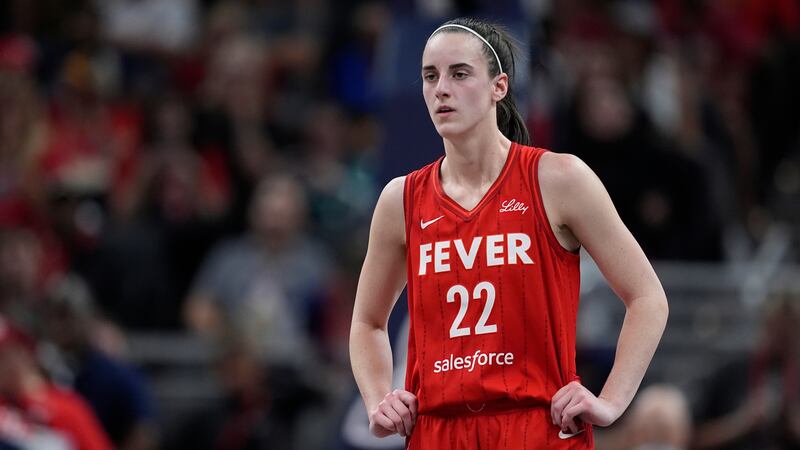 Indiana Fever's Caitlin Clark watches during the first half of a WNBA basketball game against...