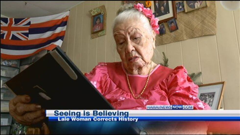 Katherine Lowe peruses the photo in question.