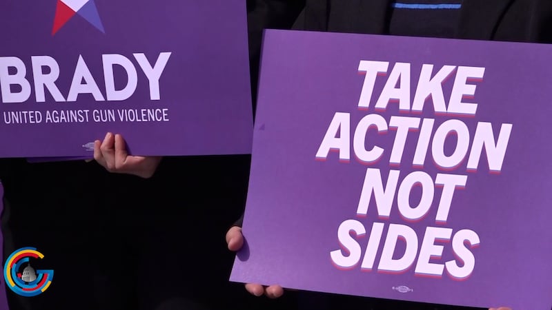 Signs at a press conference on gun control