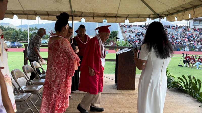 Mr. Stanley Oshima is presented with his high school diploma at Kauai High's graduation May...