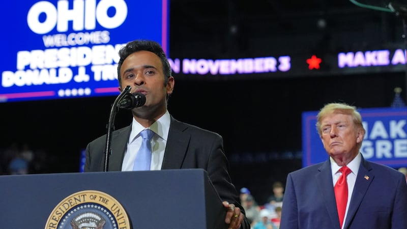 President Donald Trump listens as gubernatorial candidate Vivek Ramaswamy speaks at a campaign...