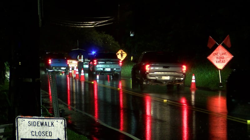 A line of cars heads toward the North Shore in a single contraflow lane at Waimea Bay.