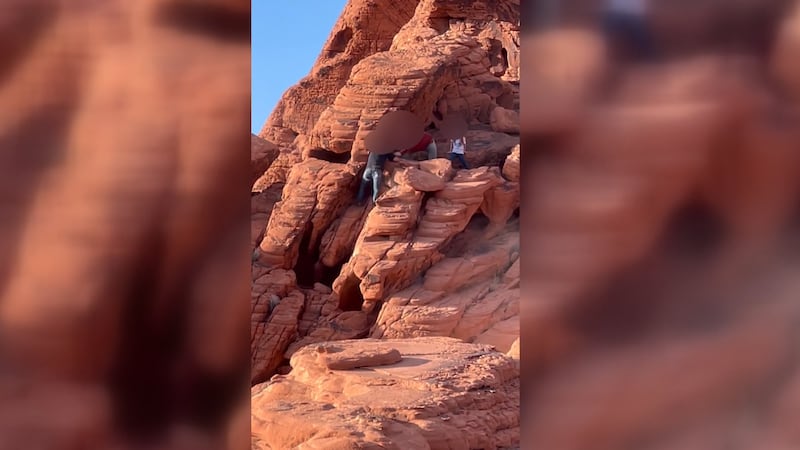 Men are seeing destroying red rocks near Lake Mead.