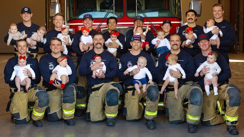 The firefighters and their babies got together for a big group photo with all but a few...