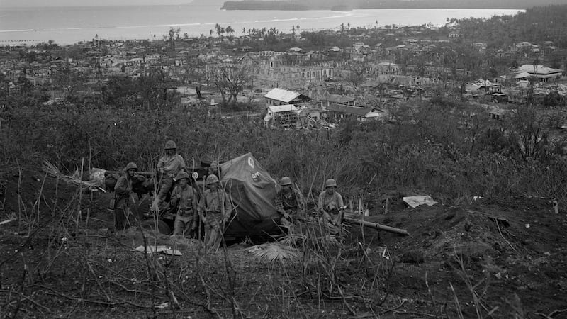 FILE - This August, 1944 file photo shows a group of U.S. soldiers siting in the foothills...
