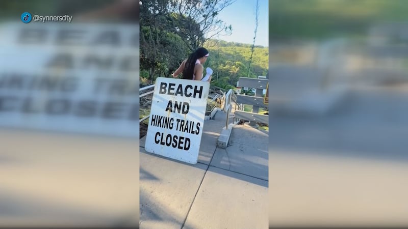 A tourist apologizes after entering closed Waianapanapa State Park during Hurricane Nolo,...