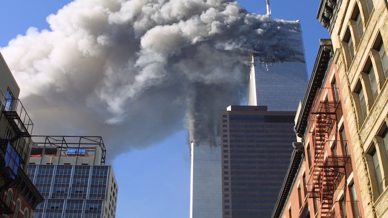 The twin towers of the World Trade Center burn after hijacked planes crashed into them on...
