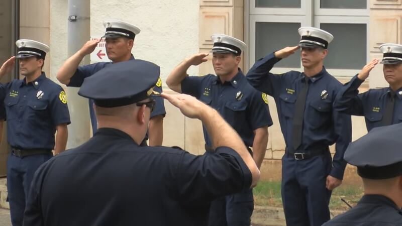 First responders lined the streets of downtown Honolulu on Wednesday in a solemn procession...
