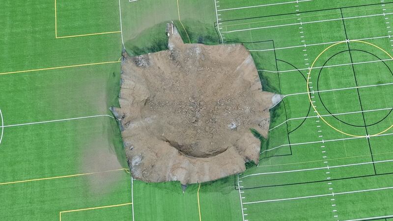 The sinkhole was estimated to be at least 100 feet wide and up to 50 feet deep.