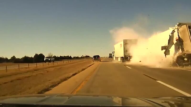 You can see debris fly and scatter in the air from the crash, causing a minivan to swerve onto...