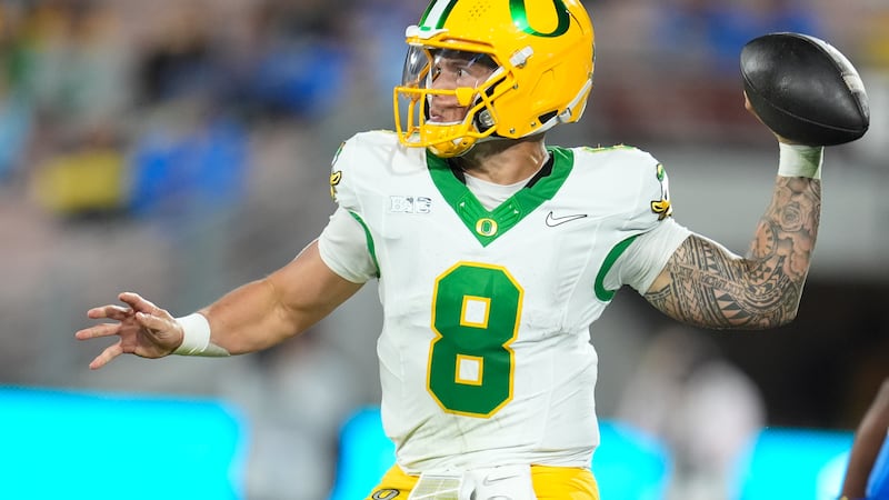 Oregon quarterback Dillon Gabriel (8) throws a pass during the second half of an NCAA college...