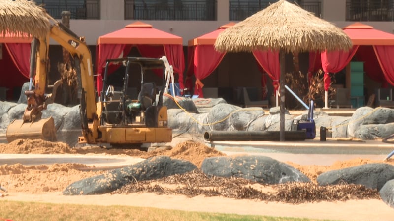 Crews use heavy equipment to cleanup sand from the Sheraton Kauai Resort in Poipu.