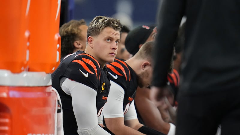 FILE - Cincinnati Bengals quarterback Joe Burrow (9) looks out from the bench during the first...