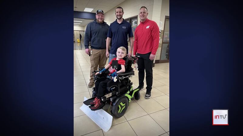 Wisconsin boy uses wheelchair to become a big help around his school