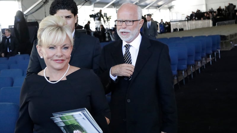 FILE - In this March 2, 2018 file photo, Televangelist Jim Bakker, right, walks with his wife...