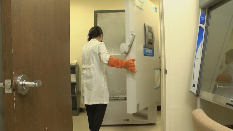 Doris Di opens up the freezer to grab a wastewater sample.