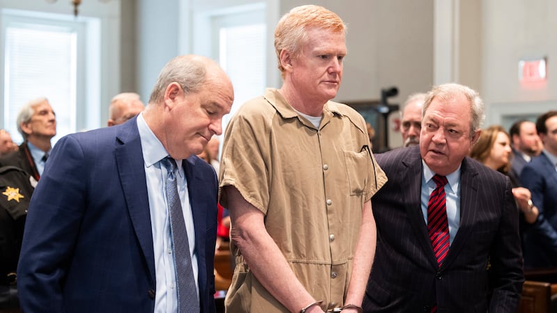 FILE - Alex Murdaugh speaks with his legal team before he is sentenced to two consecutive life...