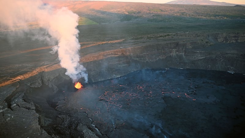 An early morning view of summit of Mauna Kea, the flank of Mauna Loa, and the current eruption...