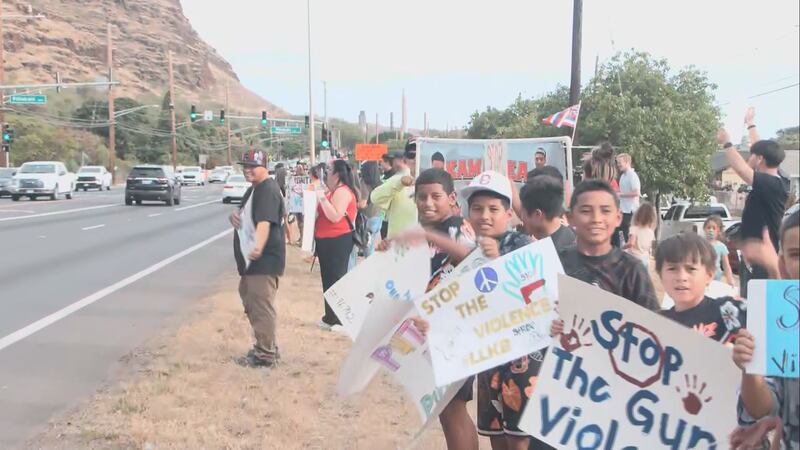 Dozens of West Oahu residents waved signs on Farrington Highway, calling for an end to gun...
