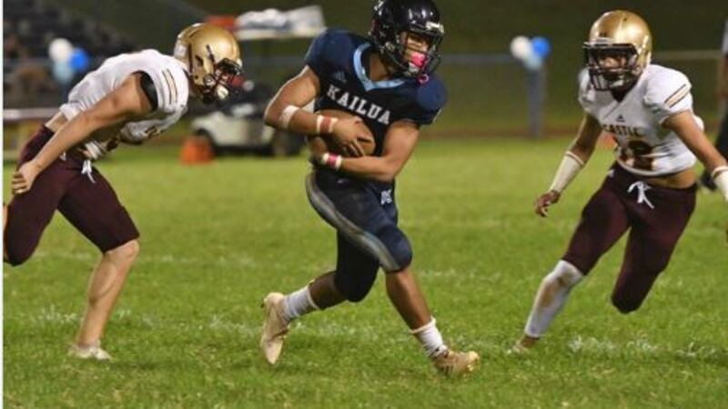 Surfriders running back Samson Rasay eludes defenders during home-coming game against Castle.