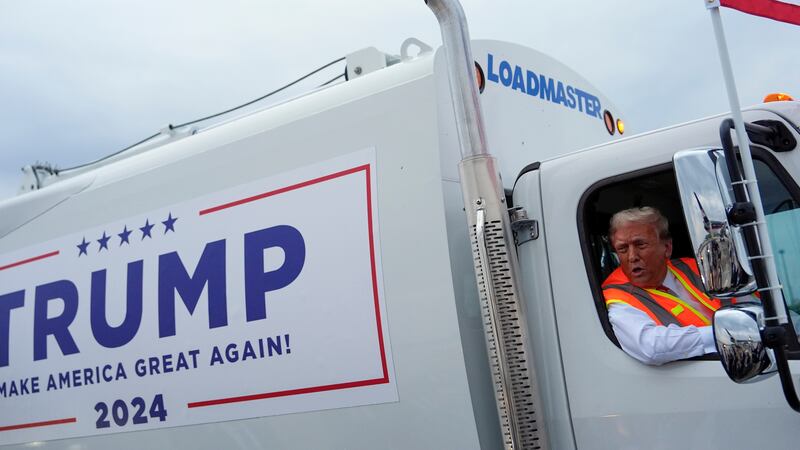 Donald Trump talks to reporters as he sits in a garbage truck Wednesday, Oct. 30, 2024, in...
