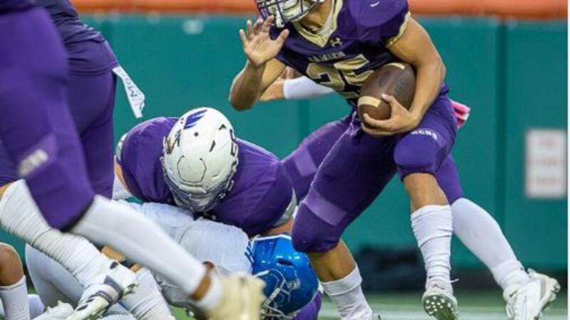 Monarch running back Amo Sulu searches for running room in second half against #8 Moanalua